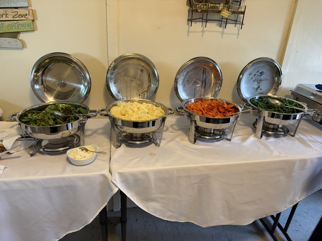 Colorful buffet sides in polished chafing dishes